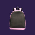 A pink and gray backpack or school bag lying flat on a ribbed green surface, photographed in bright sunlight with a strong shadow.