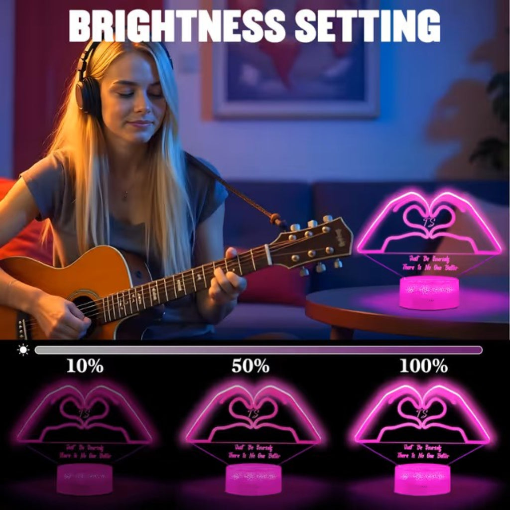 A promotional graphic showing a woman with headphones and an acoustic guitar in a dimly lit room, alongside a pink LED heart-shaped night light labeled with brightness settings 10%, 50%, and 100%. The text 'BRIGHTNESS SETTING' appears at the top.