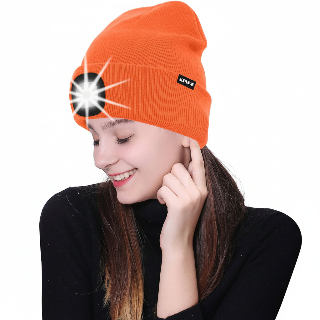 Warm LED lighted beanie cap on model with illuminated headlamp beam