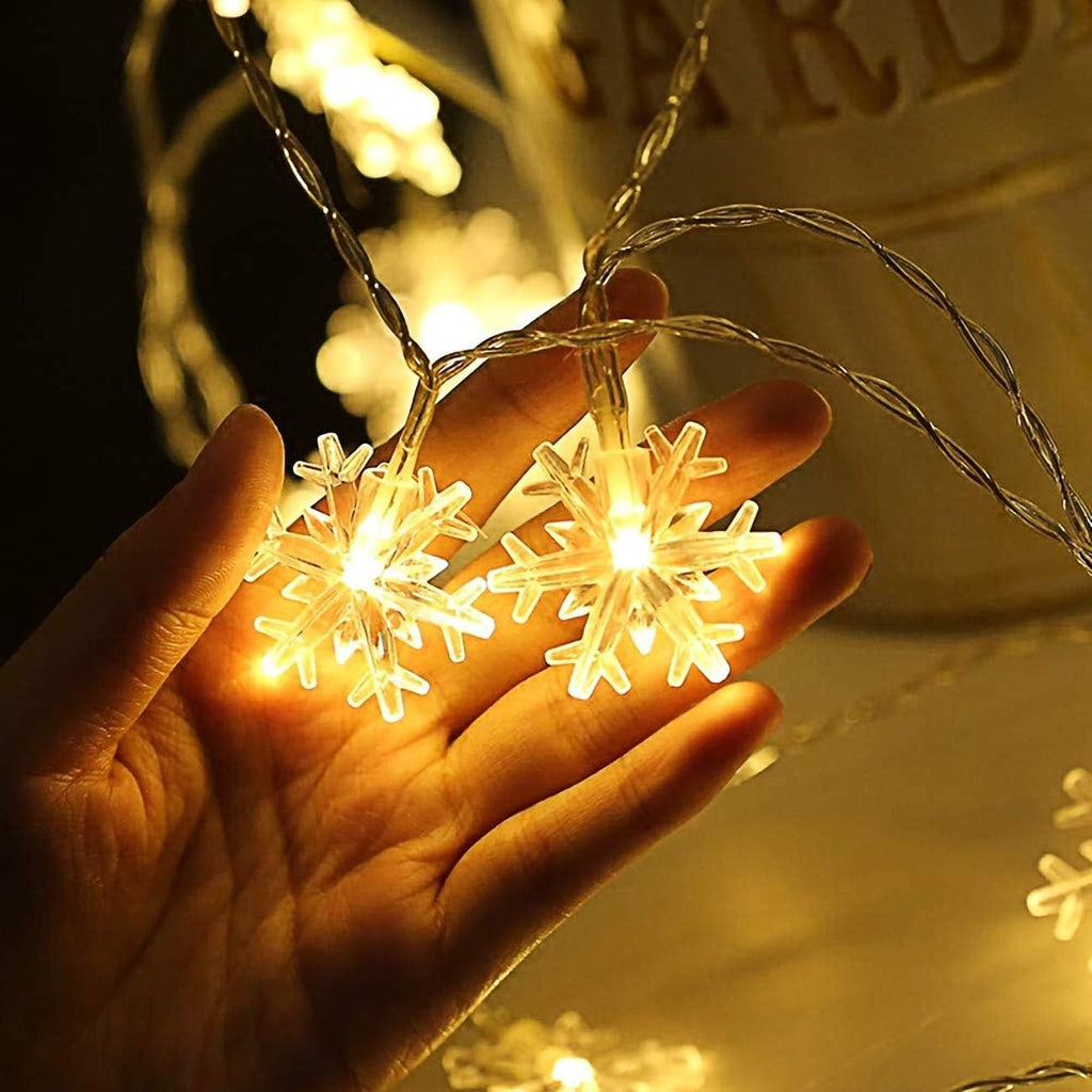 Close-up of clear faceted LED snowflake string lights with flexible silver wire