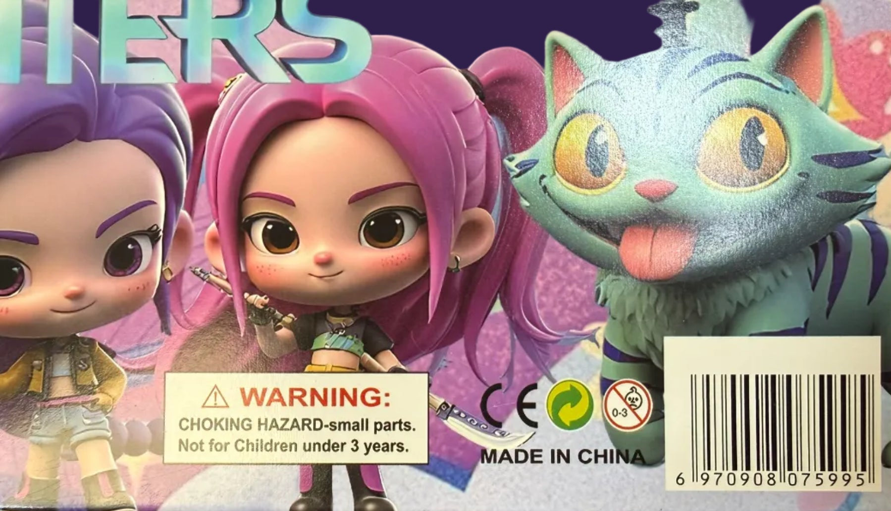 Colorful toy packaging with a character and warning label on a reflective surface.