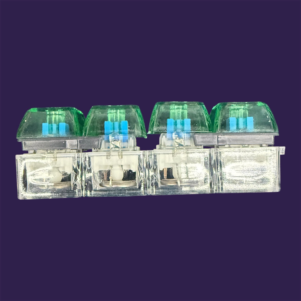 Translucent mechanical keyboard switches with cyan stems and moss-green keycaps on purple background