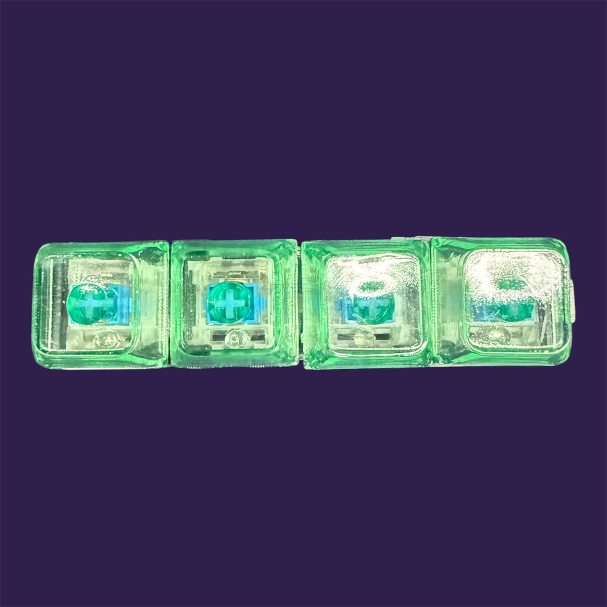 Translucent neon green mechanical keyboard switch fidget toy keychains on a purple backdrop