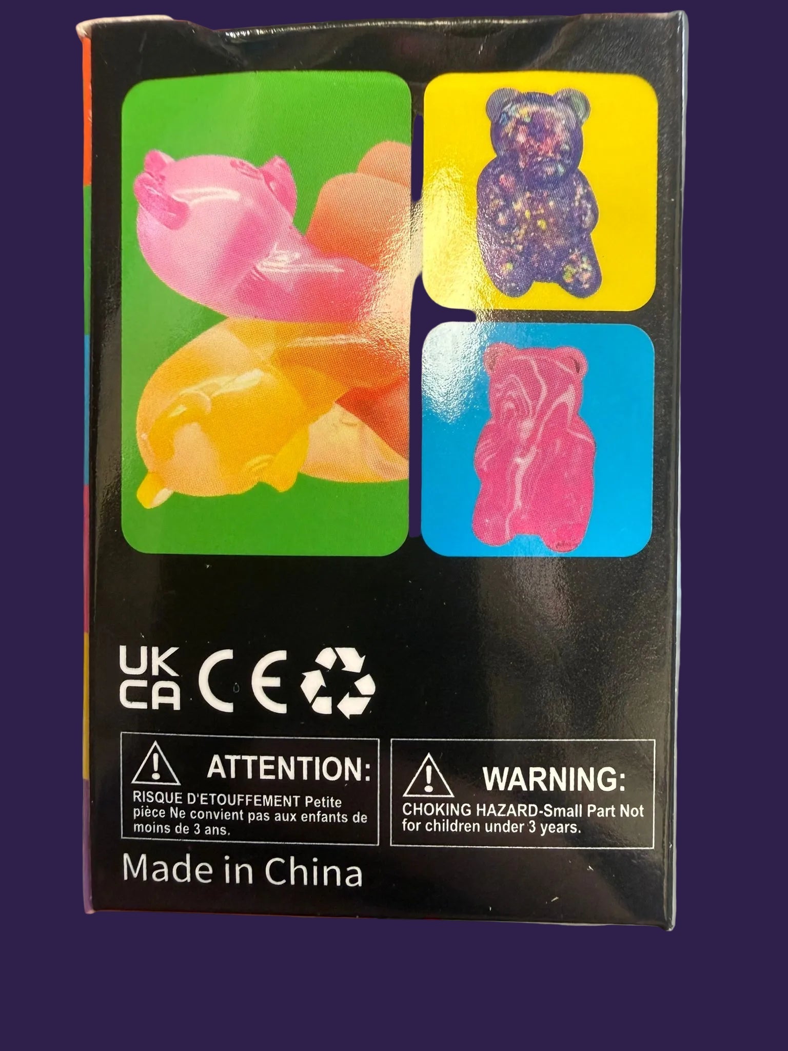 Back of Squishy Gummy Bear toy packaging featuring safety compliance marks and warning labels
