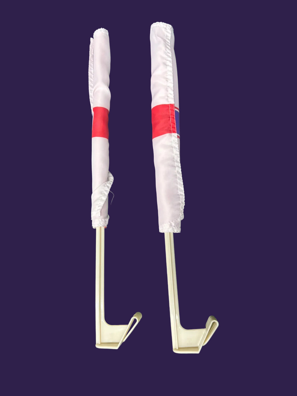Metal hooks with red and white handles on a green textured background