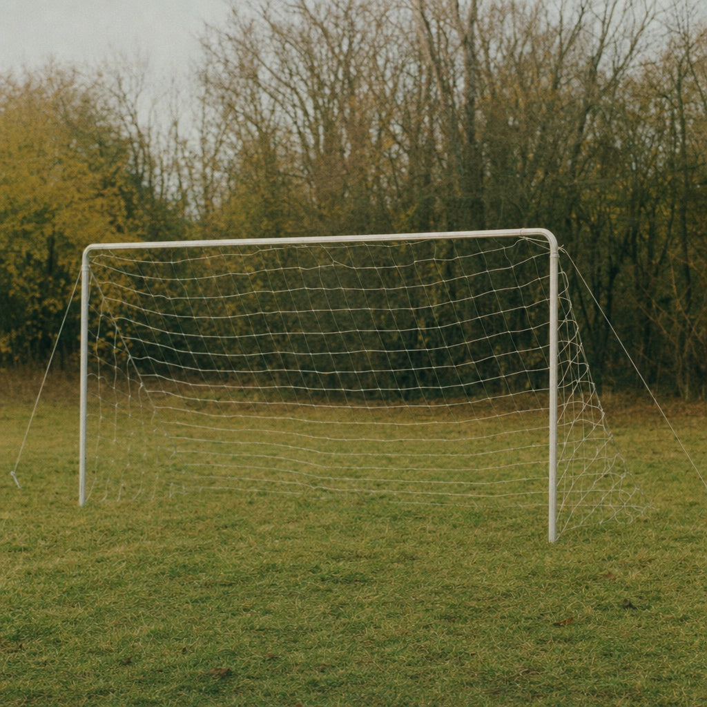 Portable Soccer Goal frame anchored using heavy duty metal stakes on grass