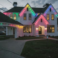 House exterior with colorful string lights during evening.