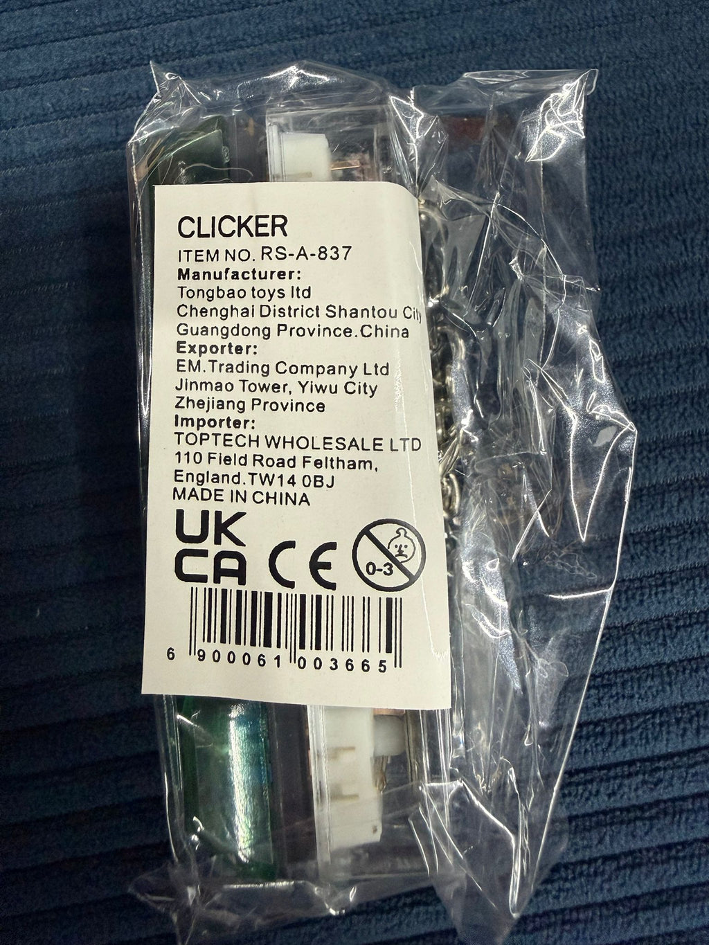 Sealed 'Clicker' mechanical keyboard switch keychain in packaging with metal chain