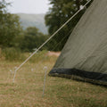 Heavy Duty Galvanised Steel Tent Peg securing guide line in grassy ground