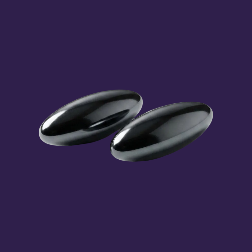 Minimalist tabletop shot of charcoal-black oval magnets