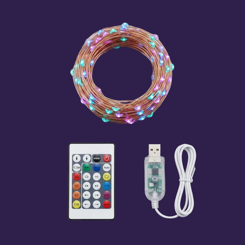 Flat lay view of coiled copper LED string lights, remote, and USB adapter