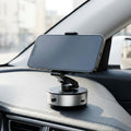 Magnetic car phone holder installed on dashboard in daylight car interior