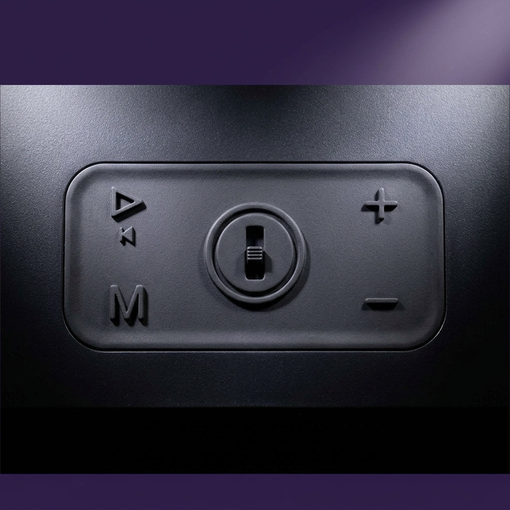Macro close-up detail of the soft-touch control buttons on top of the black wireless speaker