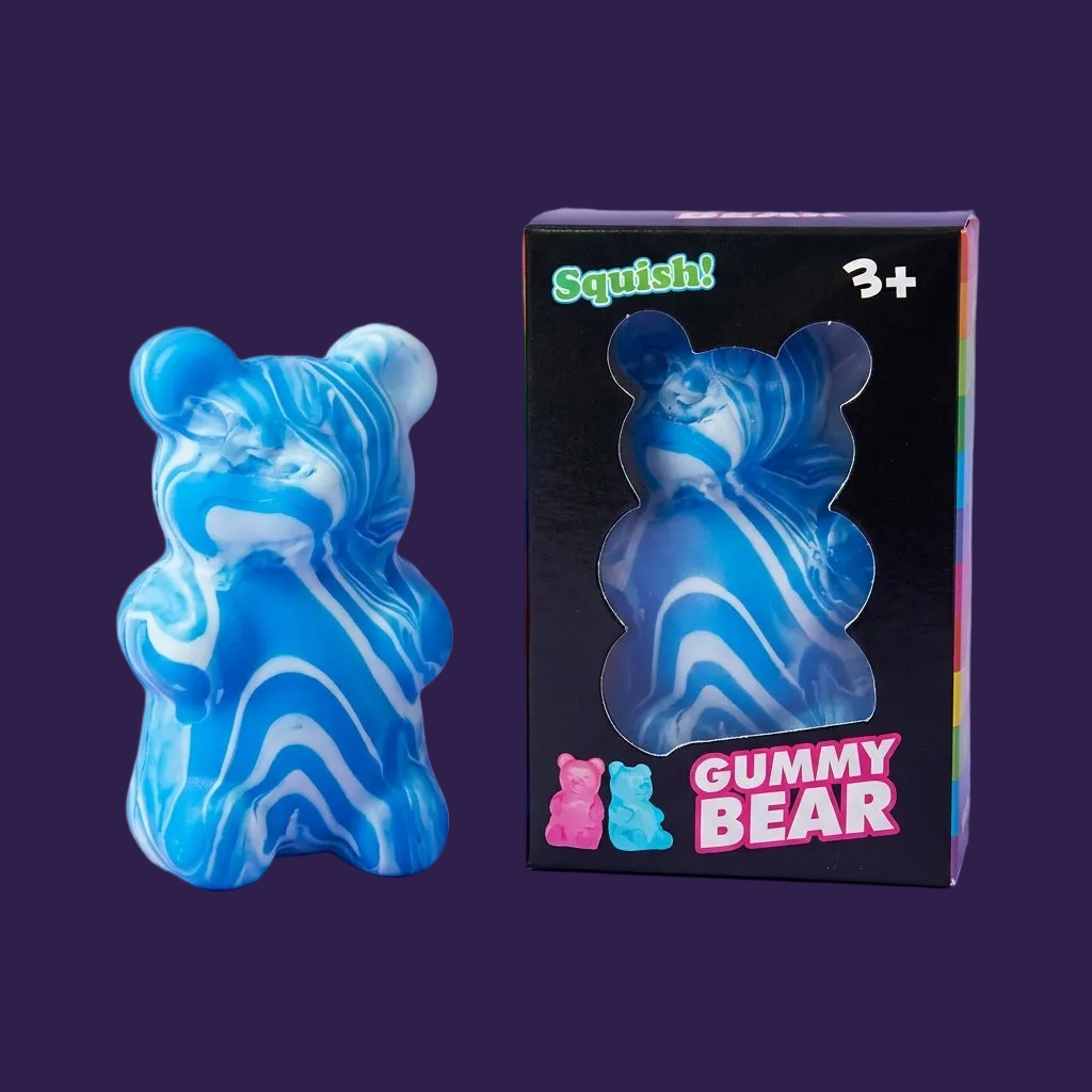 Squishy Gummy Bear toy with its black display box packaging on a pastel purple background