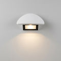 Modern minimalist curved LED wall sconce on plaster wall