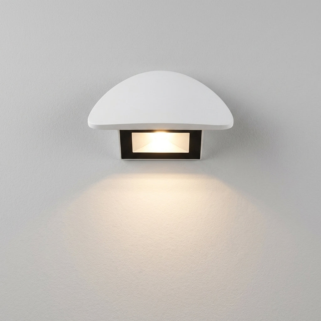 Modern minimalist curved LED wall sconce on plaster wall
