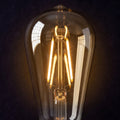 Amber-tinted 6W LED filament bulb close-up details showing glowing filament