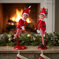 Elves Behaving Badly display stands on Christmas fireplace mantel